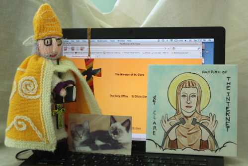 Photo of the Mission of St. Clare: a computer, an icon, two cats, a bishop